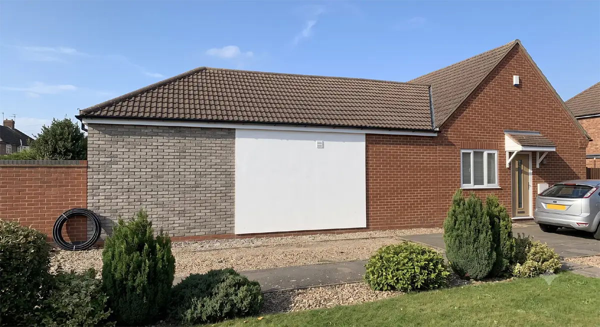 Comparison of render, external wall insulation board and brick slip cladding on a building exterior
